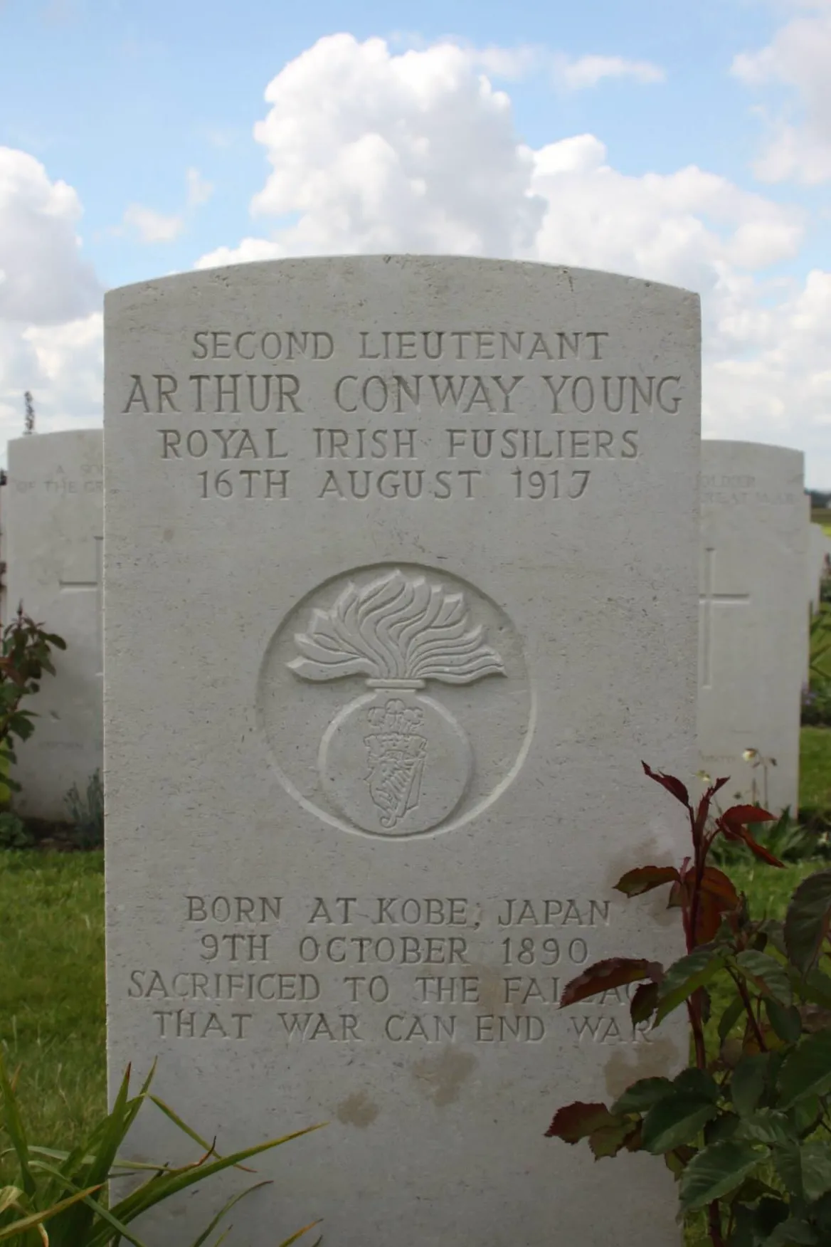 The headstone of Arthur Conway Young, the person born furthest away from the conflict in Kobe, Japan; died at age 26. The inscription reads 'Sacrificed to the fallacy that ware can end war'.