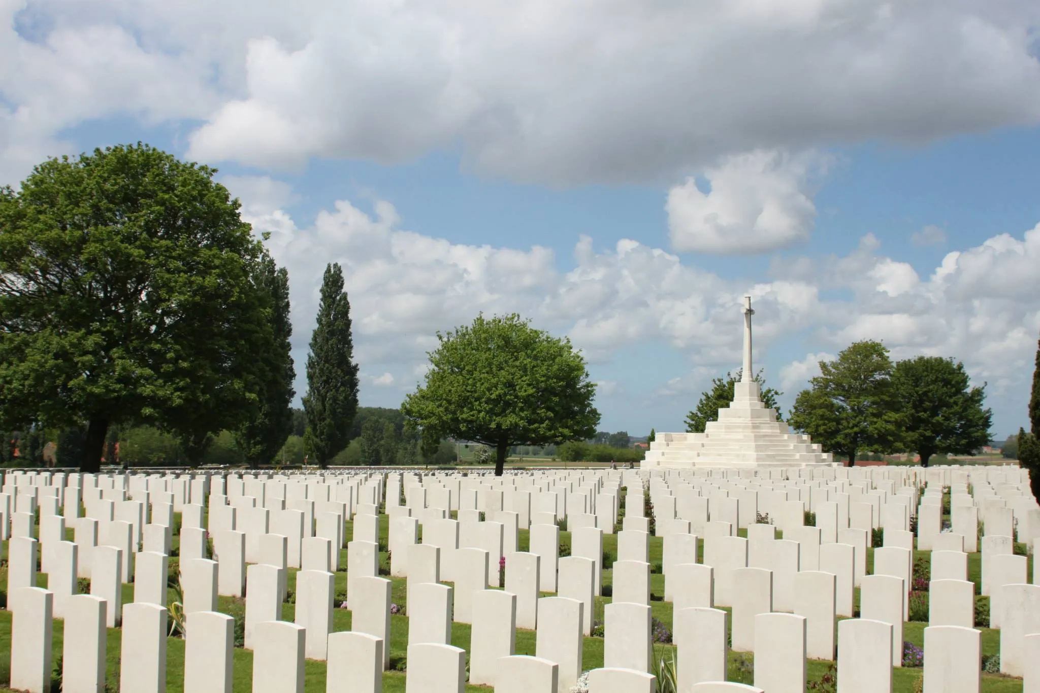 Headstones face a central monument '